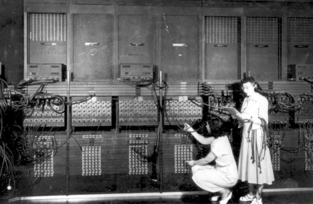 women plugging wires into Eniac