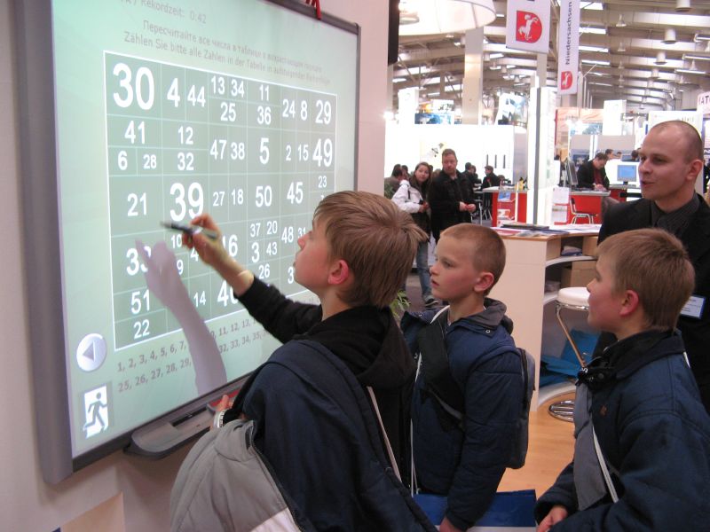 young students using an interactive whiteboard