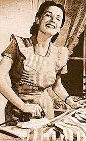 happy looking woman using an electric iron